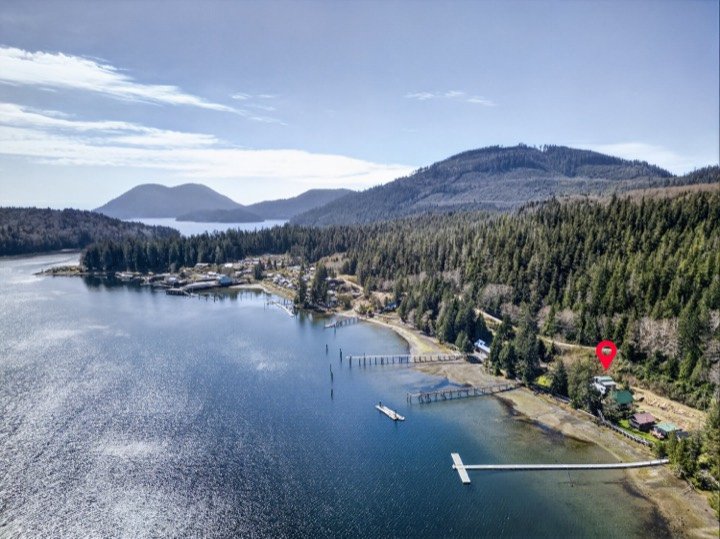 Aerial view of an oceanfront community with a marked property location