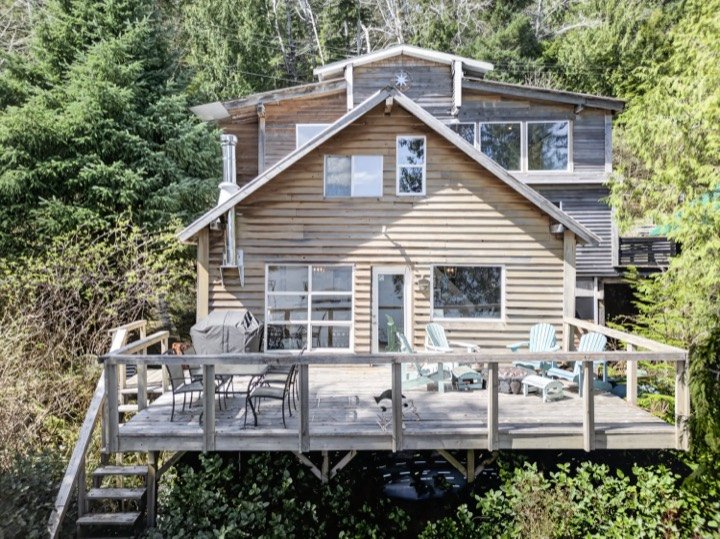 Aerial view of a waterfront cabin with a large deck