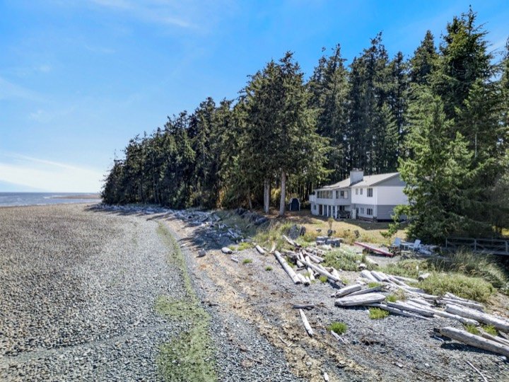 Aerial view of a beachfront home along the shoreline