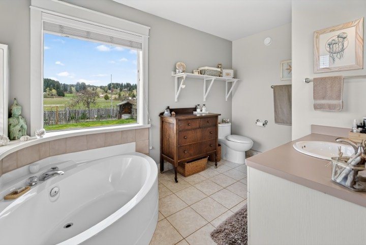 Bathroom with a soaker tub and window