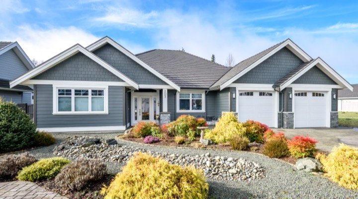 Craftsman-style rancher with stone accents and a landscaped front garden