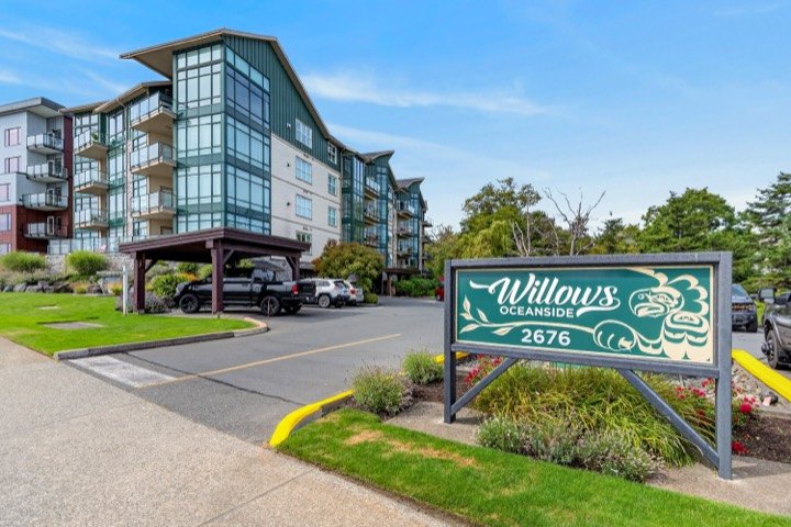 Oceanside condo building with a landscaped entrance