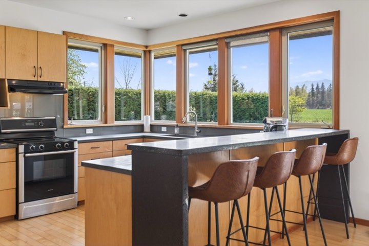 Modern kitchen with a breakfast bar and rural views