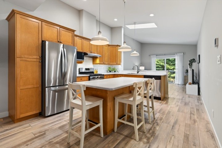 Open kitchen with island seating and a skylight
