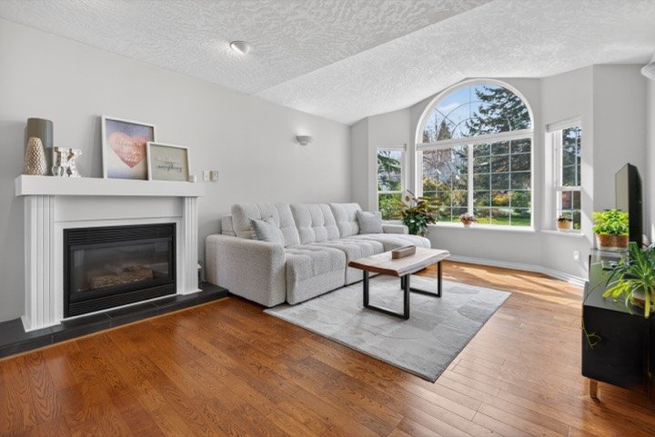 Living room with a fireplace and arched window