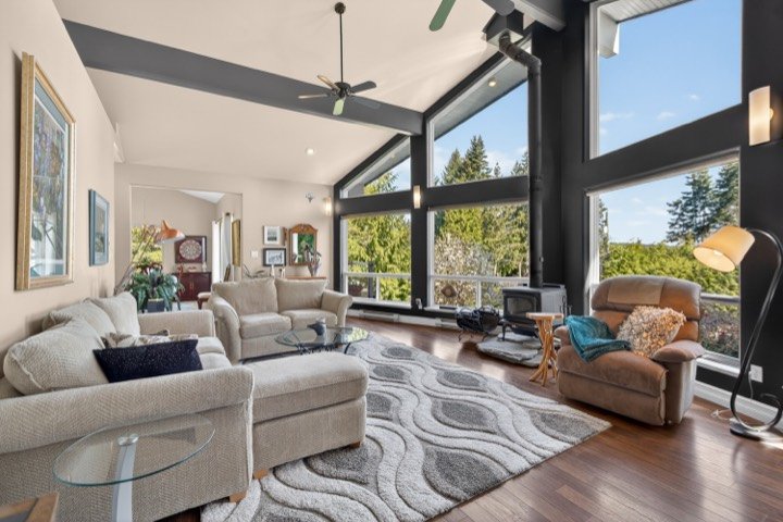 Vaulted living room with floor-to-ceiling black-framed windows