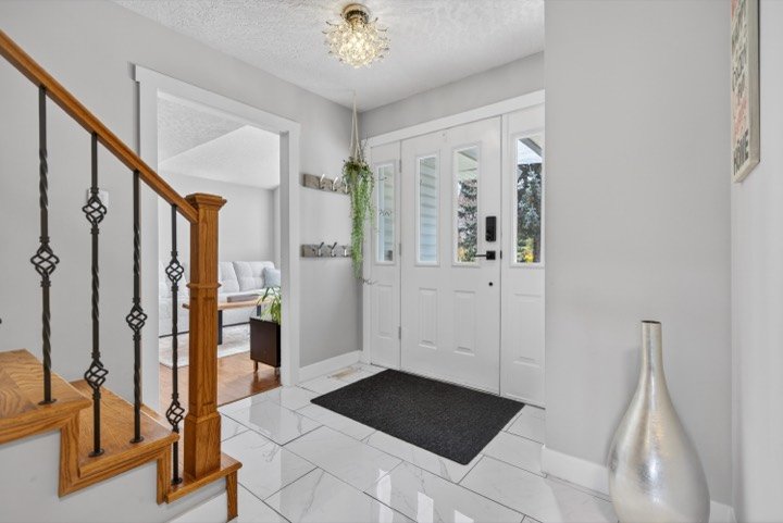 Bright entry with a staircase and tiled floor